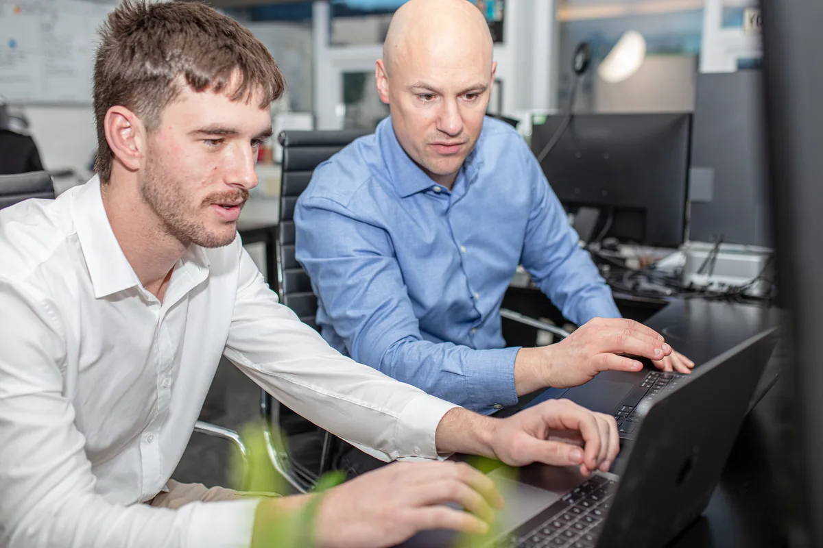 David and Luke from Halizona at a laptop in the office