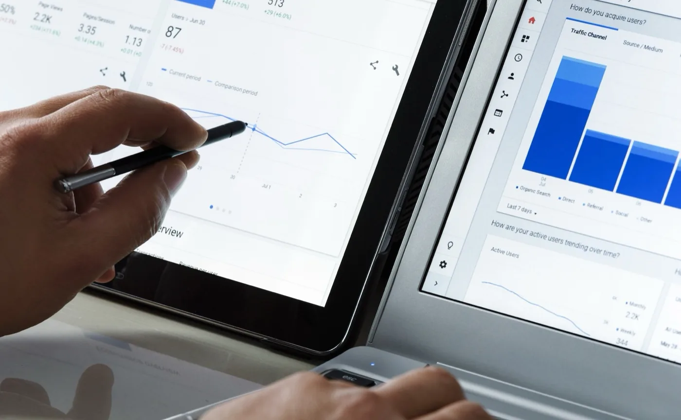 Search traffic and rankings being reviewed on a tablet and a laptop